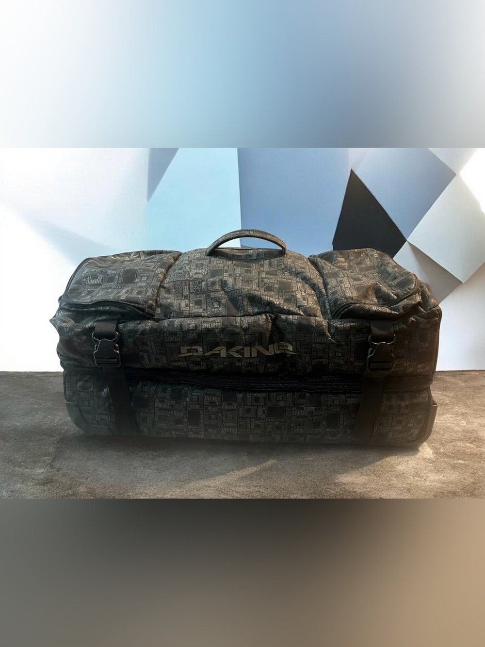 Dakine Split Roller 110L Wet Dry Duffel with a distinctive geometric pattern.